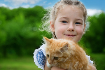 Lovely girl with a red kitten