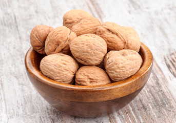 Walnuts on rustic wooden table