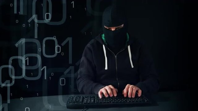 Computer hacker typing on keyboard, black copy-space background