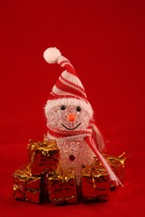 Christmas still life with snowman on a red background