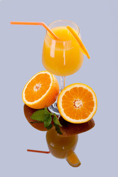Glass of orange juice with fruit isolated on white,full reflecti
