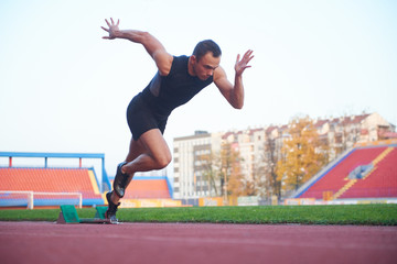 pixelated design of woman  sprinter leaving starting blocks