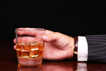 rich and success business man holding in hand glass of alcohol s