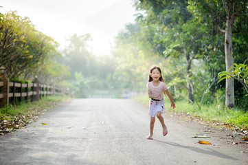 Girl running under tree