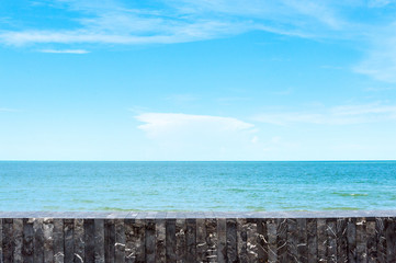 Stone tile wall on sea and sky background