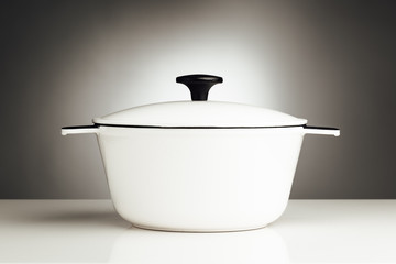 white saucepan, kitchen pot on grey background