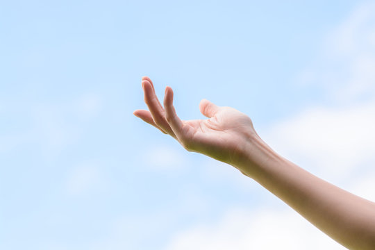 Young woman hand on sky