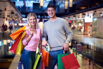 young couple with shipping bags