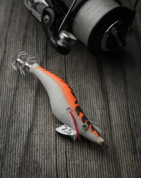 Fishing tackle squid lure on wooden background