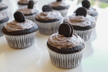 Homemade dark chocolate cupcakes with cookie and cream frosting