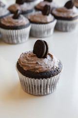 Homemade dark chocolate cupcakes with cookie and cream frosting