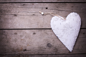Decorative heart on  vintage wooden  background.