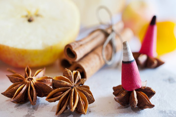 traditional Czech christmas - smoking incense cones on star anise spice with whole cinnamon and apple