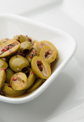 Split olives in white bowl
