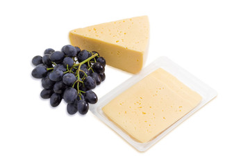 Piece of cheese, sliced cheese and bunch of grapes