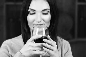 Portrait of beautiful woman drinking wine, black and white retro stylization