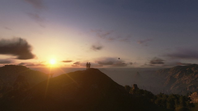 Couple on top of the mountain, timelapse sunrise, camera panning