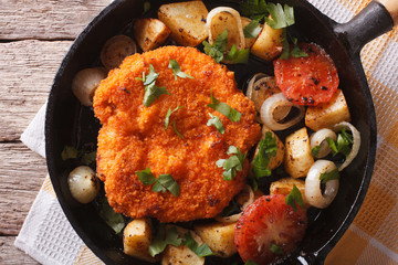 Homemade schnitzel and vegetables on pan close-up. horizontal top view
