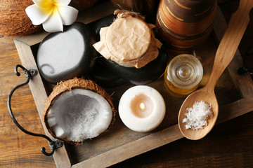 Spa coconut products on dark wooden background