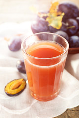 Plum Juice in a glass with fresh fruits