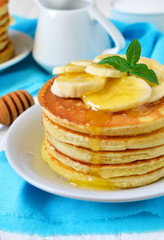 Pancake with banana, covered with honey or maple syrup