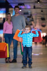 young family with shopping bags