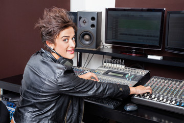 Confident Woman Mixing Audio In Recording Studio