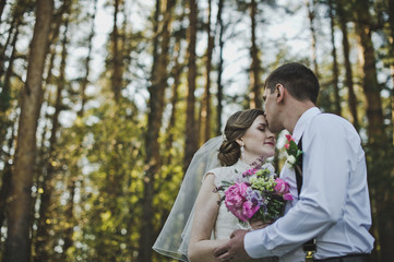 The tender embrace of the newlyweds in the woods 3950.