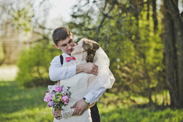 Newlyweds hugging on the background of the forest 3969.