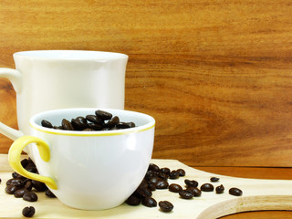 studio shot of coffee beans on wooden background still life