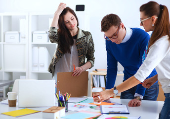 Fototapeta premium Young business people working at office on new project