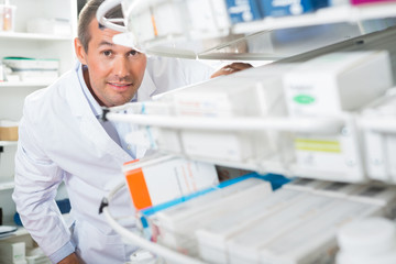 Confident Chemist Counting Stock In Pharmacy