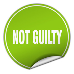 not guilty round green sticker isolated on white