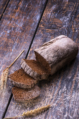 Black baked bread on a wooden background