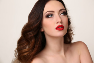 young woman with luxurious dark hair and evening makeup