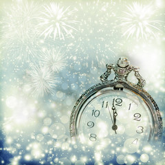 Fototapeta na wymiar Old clock with fireworks and holiday lights