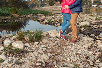 feet loving happy couple on the shore of the lake near the water