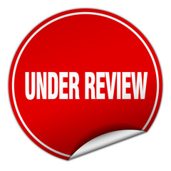 under review round red sticker isolated on white