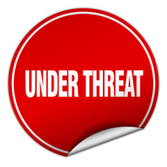 under threat round red sticker isolated on white