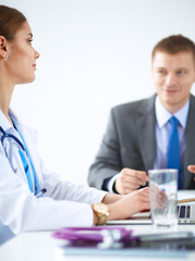 Medical team sitting at the table in modern hospital