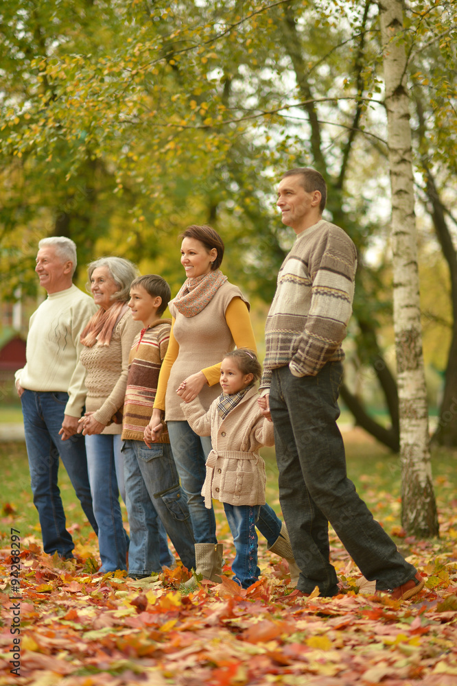 Wall mural Family relaxing in autumn park