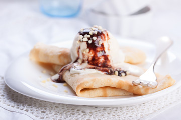 Pancakes with a scoop of ice cream on a white background.