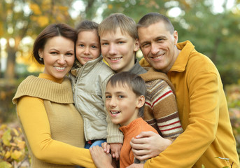 Family relaxing in autumn park