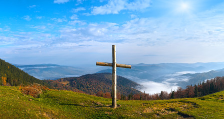 Fototapeta na wymiar Cross on mountain and sunshine