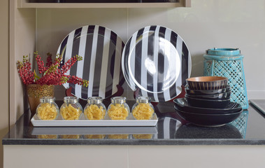 Fusilli jars and stripe plate setting on the counter