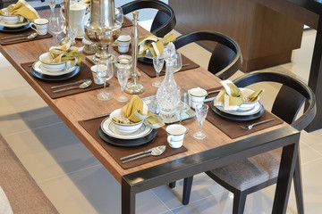 dining wooden table and comfortable chairs in modern home with e