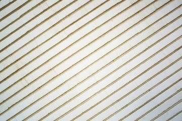 Stone white pavement with diagonal stripes as a background, top
