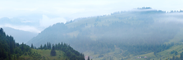 Misty morning summer mountain village