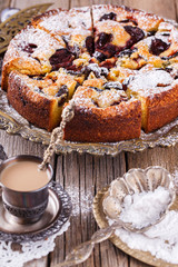 Plum cake with powdered sugar and a Cup of coffee.selective focus
