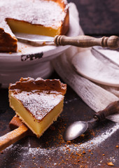 Flan at home, sprinkled with powdered sugar.selective focus